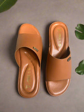 Load image into Gallery viewer, Pair of brown sandals on a textured surface