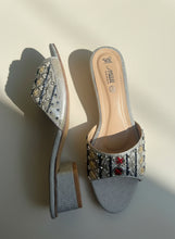 Load image into Gallery viewer, Pair of embellished high-heeled shoes on a concrete surface
