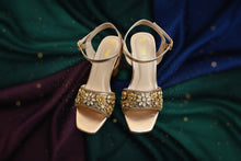 Load image into Gallery viewer, Gold embellished sandals on a gray surface