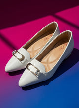 Load image into Gallery viewer, Pair of light gray pointed-toe shoes with a decorative strap on a concrete surface