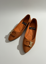 Load image into Gallery viewer, Pair of orange shoes with a gold buckle on a dark surface