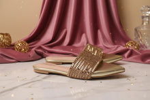 Load image into Gallery viewer, Gold sandals with rhinestone details on a marble surface with pink fabric and decorative balls in the background.