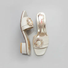Load image into Gallery viewer, Pair of white high-heeled shoes with decorative buckles on a gray surface