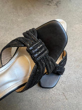 Load image into Gallery viewer, Black strappy sandal with white sole on a gray surface
