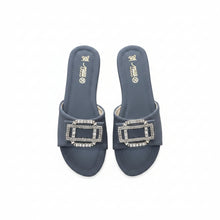 Load image into Gallery viewer, A pair of dark slate blue slide sandals with large rectangular silver rhinestone-embellished buckles, displayed on a textured gray surface.