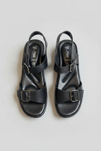 Load image into Gallery viewer, Pair of black sandals with buckles on a beige surface