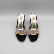Load image into Gallery viewer, Black high-heeled shoes with colorful embellishments on a gray surface