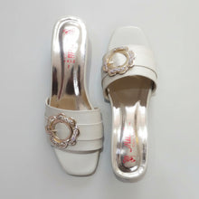 Load image into Gallery viewer, White high-heeled shoes with decorative buckles on a gray marble surface
