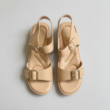 Load image into Gallery viewer, Pair of beige sandals with buckles on a gray surface