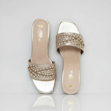 Load image into Gallery viewer, Pair of silver high-heeled shoes with embellishments on a gray surface