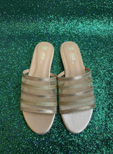 Load image into Gallery viewer, Pair of sandals with metallic straps on a textured surface