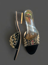 Load image into Gallery viewer, Black high-heeled shoes with decorative embellishments on a gray surface