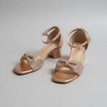 Load image into Gallery viewer, Bronze high-heeled sandals with decorative straps on a gray surface