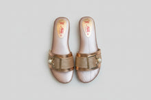 Load image into Gallery viewer, Pair of gold and pearl embellished sandals on a gray surface