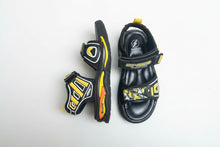 Load image into Gallery viewer, Black and yellow children's sandals on a gray surface