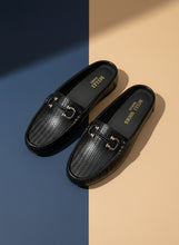 Load image into Gallery viewer, Black loafers with a gold buckle on a gray surface