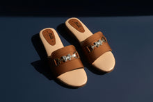 Load image into Gallery viewer, Brown sandals with decorative straps on a stone surface