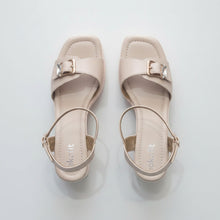 Load image into Gallery viewer, Pair of beige high-heeled sandals with buckles on a gray surface