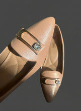 Load image into Gallery viewer, Pair of beige shoes with decorative buckles on a reflective surface