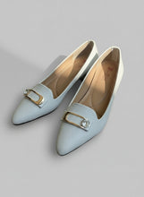 Load image into Gallery viewer, White pointed-toe shoes with a decorative buckle on a gray surface