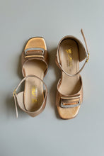 Load image into Gallery viewer, Pair of gold sandals with rhinestone embellishments on a gray surface
