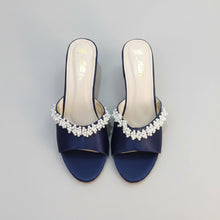 Load image into Gallery viewer, Pair of navy blue sandals with pearl embellishments on a gray surface