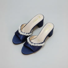 Load image into Gallery viewer, Navy blue sandals with pearl embellishments on a gray marble surface