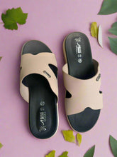 Load image into Gallery viewer, Pair of beige sandals with black soles on a textured surface