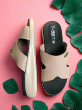 Load image into Gallery viewer, Pair of beige sandals with black soles on a textured surface