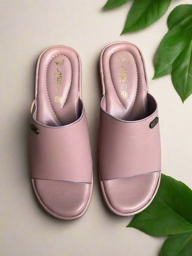 Pair of pink slides on a gray concrete floor