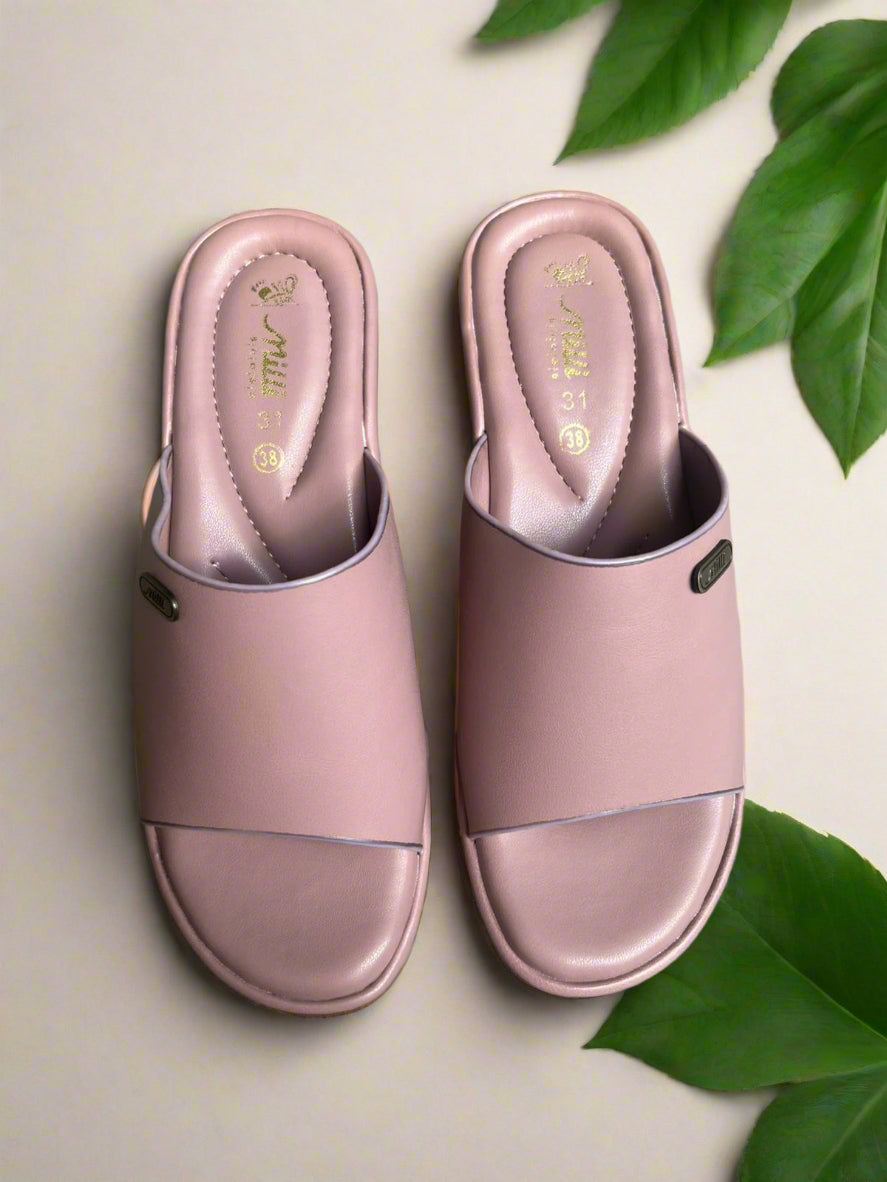 Pair of pink slides on a gray concrete floor