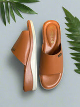 Load image into Gallery viewer, Pair of brown sandals on a gray surface
