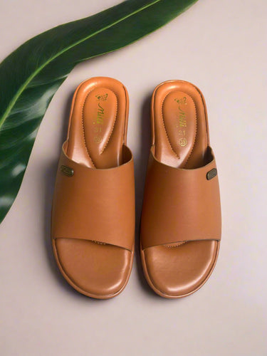 Pair of brown sandals on a textured surface