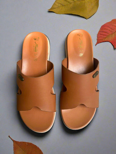 Pair of brown sandals on a gray surface