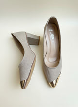 Load image into Gallery viewer, Pair of beige high-heeled shoes with gold toes on a gray surface
