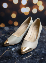 Load image into Gallery viewer, Pair of gray high-heeled shoes with metallic pointed toes on a concrete surface
