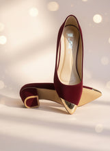 Load image into Gallery viewer, Red high-heeled shoes with gold toes on a gray surface
