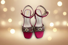 Load image into Gallery viewer, Pair of red high-heeled sandals with decorative straps on a gray surface

