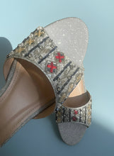Load image into Gallery viewer, Silver embellished sandal with decorative elements on a neutral background
