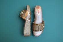 Load image into Gallery viewer, Pair of gold and pink sandals with a buckle on a gray surface
