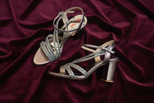 Load image into Gallery viewer, Pair of metallic high-heeled shoes on a reflective surface

