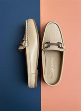 Load image into Gallery viewer, Pair of beige loafers with a decorative buckle on a gray surface
