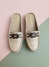 Load image into Gallery viewer, Pair of beige loafers with decorative straps on a gray surface
