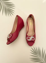 Load image into Gallery viewer, Red high-heeled shoes with gold embellishments on a dark background
