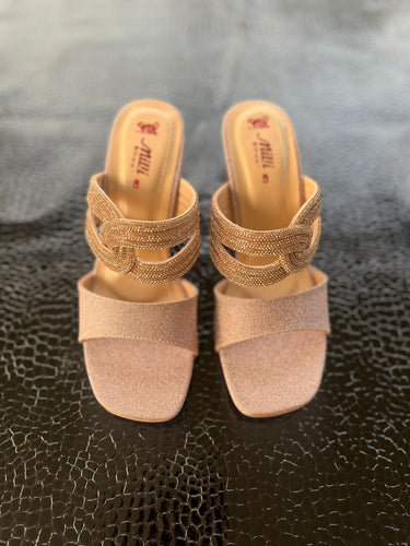 Pair of gold and beige slides with high heels