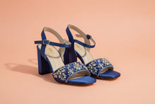 Load image into Gallery viewer, Pair of blue sandals with decorative straps on a gray surface
