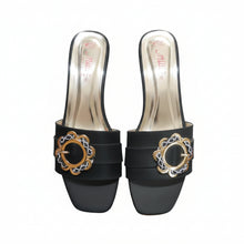 Load image into Gallery viewer, Black high-heeled shoes with decorative gold buckles on a gray surface
