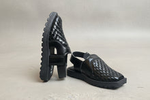 Load image into Gallery viewer, Black woven sandals on a gray surface
