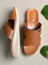 Load image into Gallery viewer, Pair of brown sandals with white soles on a gray surface
