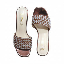Load image into Gallery viewer, Pair of brown and white patterned sandals on a gray surface
